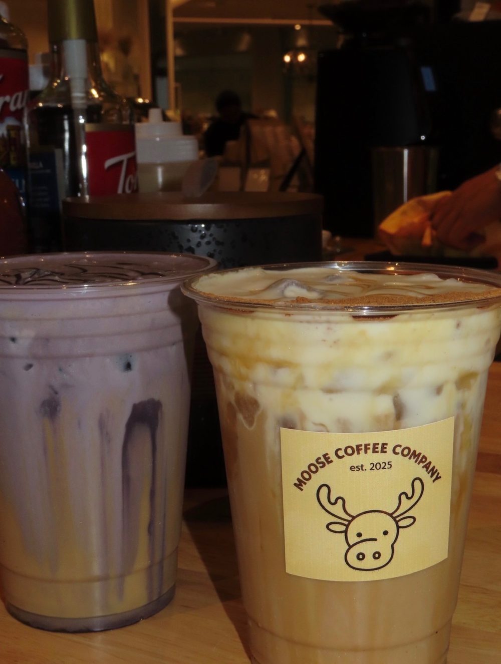 Iced latte in a branded Moose Coffee Company cup